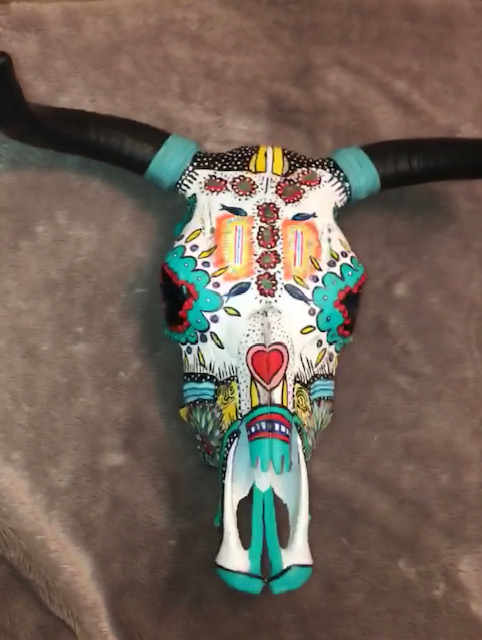 George — intricately painted decorative bull skull with vibrant folk art patterns in teal, red and yellow